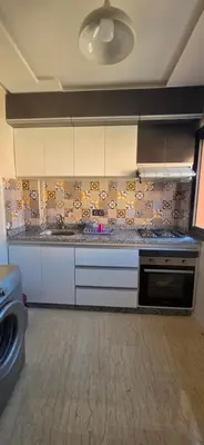 a kitchen with white cabinets and a counter top at Great modern holiday apartment Marrakesh in Marrakech