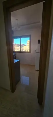an empty room with a kitchen and a window at Great modern holiday apartment Marrakesh in Marrakech