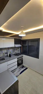 a kitchen with white cabinets and a ceiling at Great modern holiday apartment Marrakesh in Marrakech