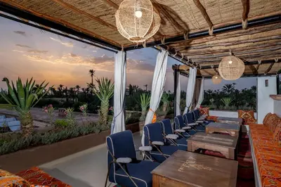 a restaurant with chairs and tables and a view of the ocean at Al destino Resort Marrakech in Marrakech