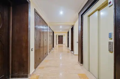 an empty corridor in a building with wooden doors at Duplex Style and Confortable au Centre de la Ville in Marrakech