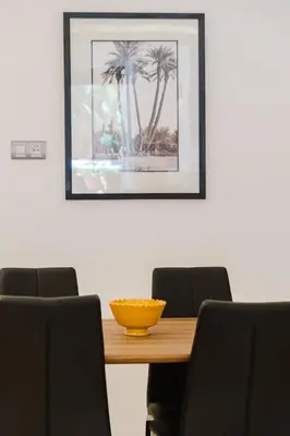 a dining room table with chairs and a yellow bowl on it at Duplex Style and Confortable au Centre de la Ville in Marrakech