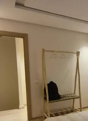 a room with a hanging bed and a mirror at Sérénité en plein Marrakech in Marrakech