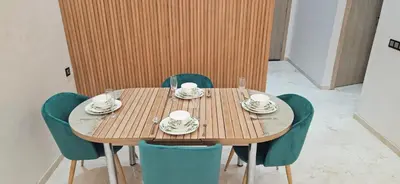 a wooden table with chairs and cups and plates on it at Elegant & Chic Retreat, Pool, Prime Location in Marrakech