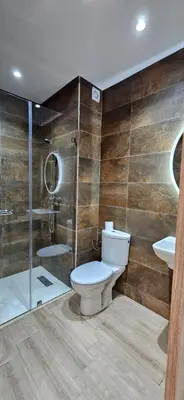 a bathroom with a toilet and a shower and a sink at Elegant & Chic Retreat, Pool, Prime Location in Marrakech