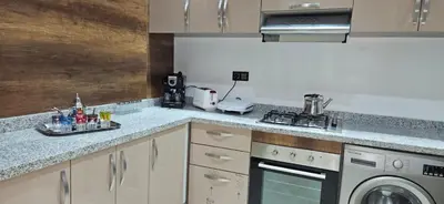 a kitchen with a sink and a washer and dryer at Elegant & Chic Retreat, Pool, Prime Location in Marrakech