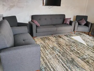 a living room with two couches and a rug at Home sweet home in Marrakech in Marrakech