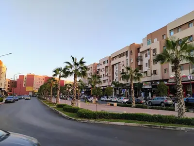 a street in a city with palm trees and buildings at Home sweet home in Marrakech in Marrakech
