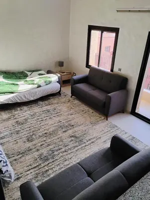 a living room with a couch and a bed at Home sweet home in Marrakech in Marrakech
