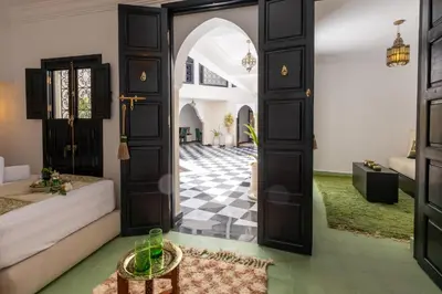 an open door into a room with a checkerboard floor at Riad Zehra in Marrakech