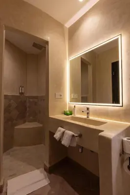 a bathroom with a sink and a mirror and a tub at Riad Zehra in Marrakech