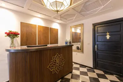 a lobby with a counter and a black door at Riad Zehra in Marrakech