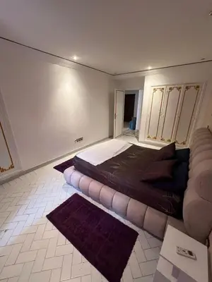 a bedroom with a bed and a couch in it at Cozy appartement en plein coeur de Guéliz in Marrakech