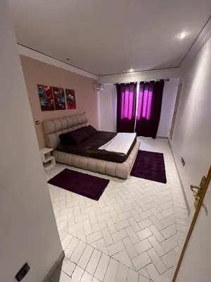 a bedroom with a bed and a purple window at Cozy appartement en plein coeur de Guéliz in Marrakech