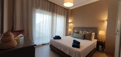 a bedroom with a bed with blue towels on it at APPART GUELIZ PLAZA MARRAKECh in Marrakech