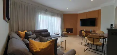 a living room with a couch and a table at APPART GUELIZ PLAZA MARRAKECh in Marrakech