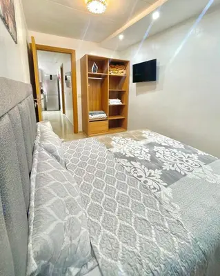 a bedroom with a large bed and a television at Opera 160&165 in Marrakech