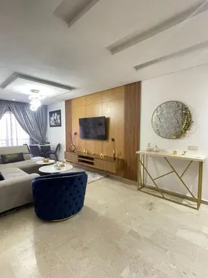 a living room with a couch and a tv at Opera 160&165 in Marrakech