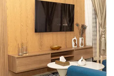 a living room with a television on a wall at Opera 160&165 in Marrakech