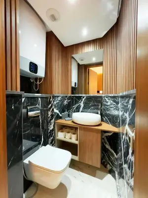 a bathroom with a toilet and a sink at Appt de Luxe avec Terrasse,PiscinePartagée & wifi in Marrakech