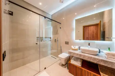 a bathroom with a shower and a sink and a toilet at Sumptuous Villa, Heated Pool, 15minutes to City Center, Daily Housekeeping, Private Cook and Chauffeur, Games in Marrakech