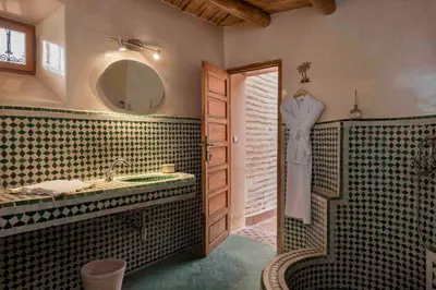 a bathroom with a sink and a mirror at Villa Grenade in Marrakech