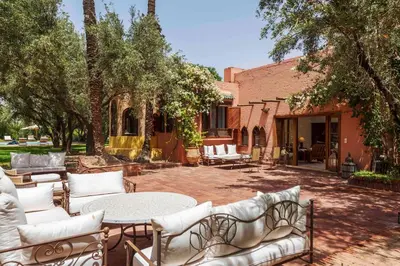 a patio with couches and a table in front of a building at Villa Grenade in Marrakech
