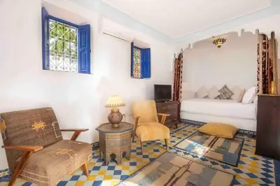 a living room with a couch and a bed at Villa Grenade in Marrakech
