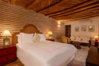 a bedroom with a large white bed in a room at Villa Grenade in Marrakech