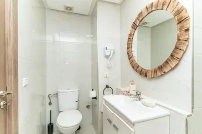 a bathroom with a white toilet and a mirror at Studio calme au cœur de Marrakech Guiliz, proche Victor Hugo in Marrakech