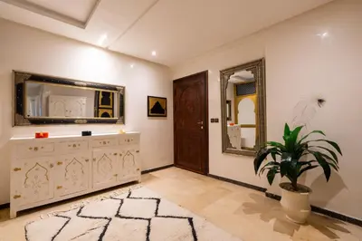 a living room with a dresser and a mirror at Gueliz family Express in Marrakech