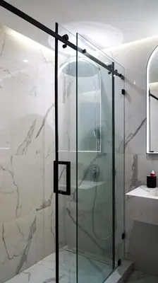 a shower with a glass door in a bathroom at Appartement de luxe au cœur du quartier majorelle in Marrakech