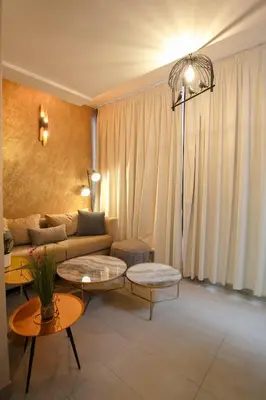 a living room with a couch and two tables at The Modern Luxury - Marrakech in Marrakech