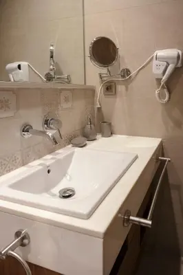 a bathroom with a white sink and a mirror at The Modern Luxury - Marrakech in Marrakech