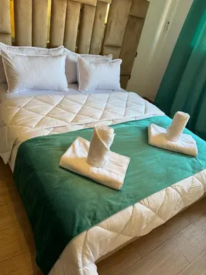 two towels on a bed with hats on it at Apartment piscine gueliz hivernage ctm train aeroport supratour in Marrakech