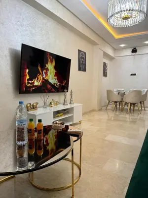 a living room with a tv and a table with drinks on it at Apartment piscine gueliz hivernage ctm train aeroport supratour in Marrakech