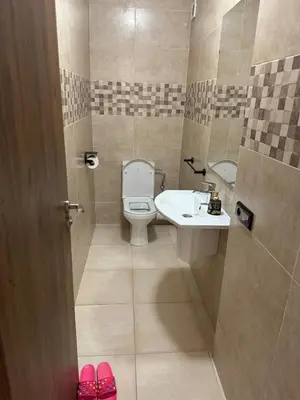 a small bathroom with a toilet and a sink at Apartment piscine gueliz hivernage ctm train aeroport supratour in Marrakech
