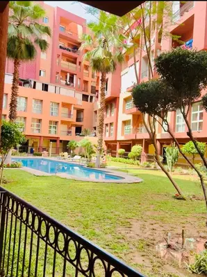 a resort with a swimming pool and a building at Appartement marrakech in Marrakech