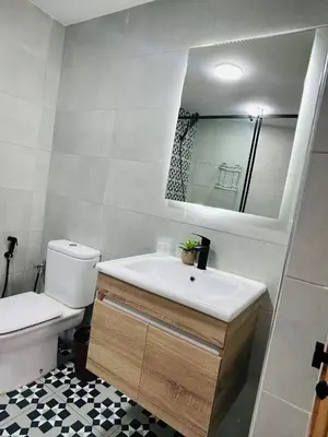 a bathroom with a sink and a toilet and a mirror at Appartement marrakech in Marrakech