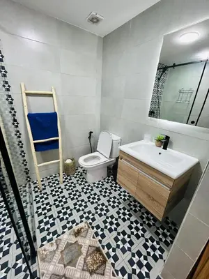 a bathroom with a toilet and a sink and a tub at Appartement marrakech in Marrakech