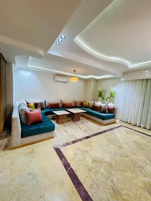 a living room with two couches and a table at Appartement marrakech in Marrakech