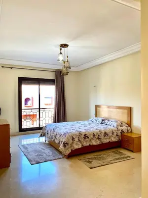 a bedroom with a bed and a window at Magnifique F3 au Riad Arfoud avec piscine in Marrakech
