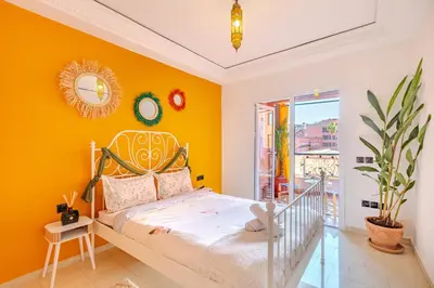 a bedroom with yellow walls and a bed at Boho chic retreat in Marrakech