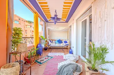 an apartment balcony with plants and a couch at Boho chic retreat in Marrakech