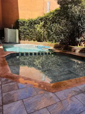 a swimming pool in the middle of a yard at Boho chic retreat in Marrakech