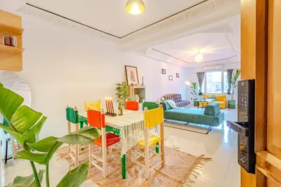 a living room with a table and chairs at Boho chic retreat in Marrakech
