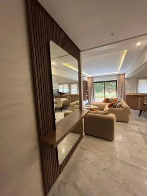 a living room with a large mirror on the wall at Appartement spacieux 1 chambre avec piscine Palmeraie Gates in Marrakech