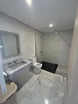a bathroom with a toilet and a sink and a mirror at Appartement spacieux 1 chambre avec piscine Palmeraie Gates in Marrakech