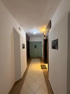 a hallway with white walls and a green door at Beautiful apartment in a very good location and free parking in Marrakech