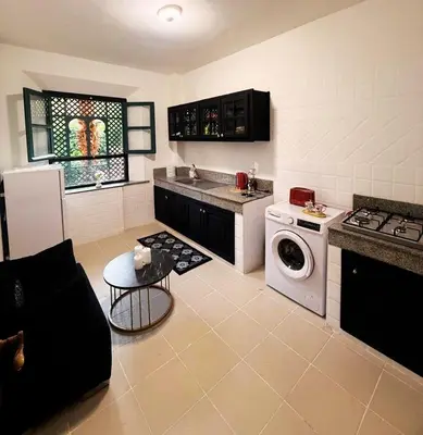 a kitchen with a washing machine and a stove at Beautiful apartment in a very good location and free parking in Marrakech
